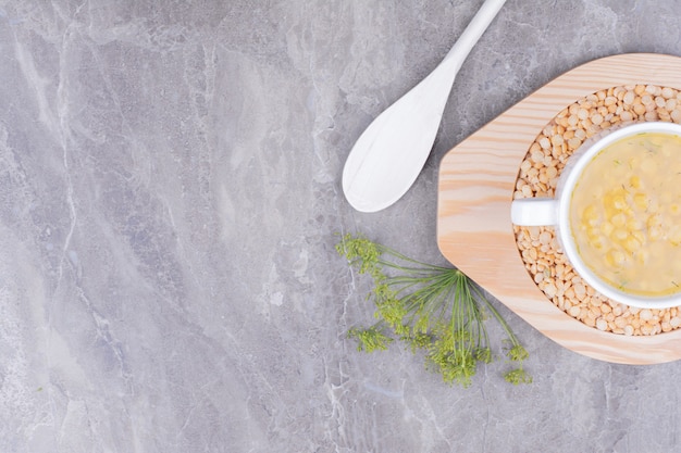 Pea beans soup in a white ceramic bowl on the marble