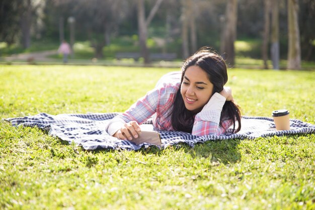 Peaceful delighted girl relaxing in park
