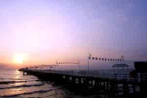 Free photo peaceful pier at sunset