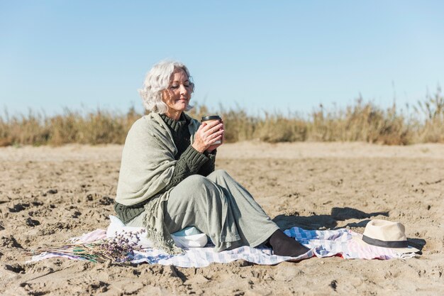 Peaceful senior woman holding coffee