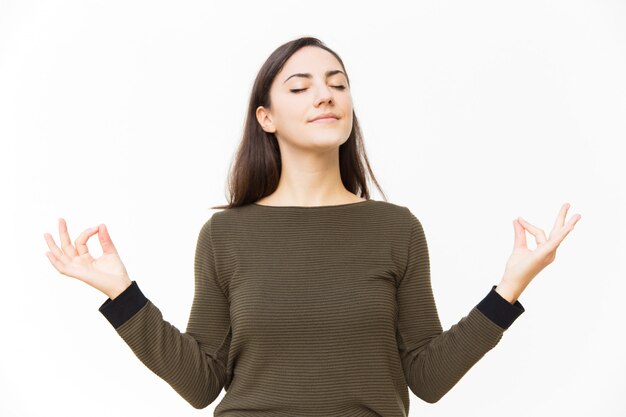 Peaceful tranquil female woman making zen gesture