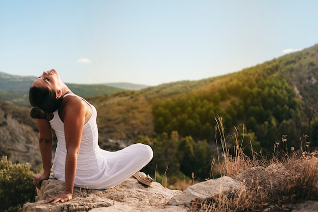 Free photo peaceful woman meditating in countryside