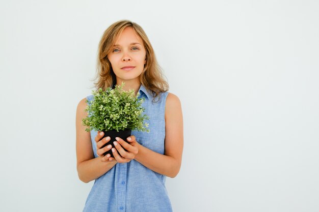 Peaceful Young Beautiful Woman Holding Pot Plant