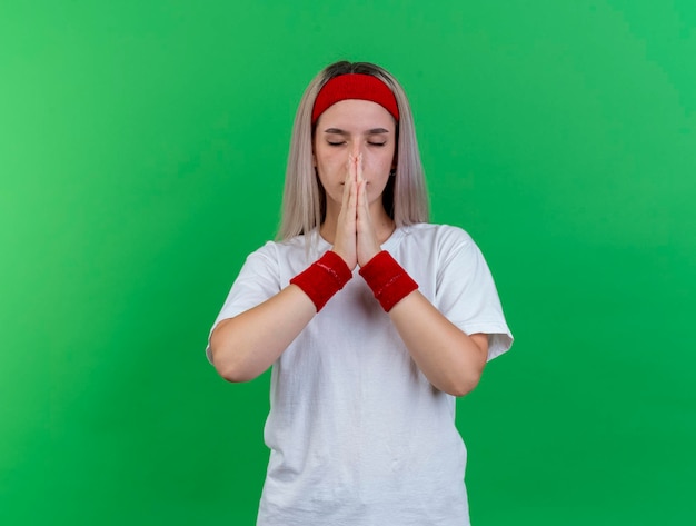 Peaceful young caucasian sporty girl wearing headband