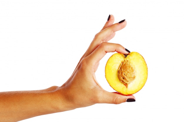 Peach fruit in woman's hand