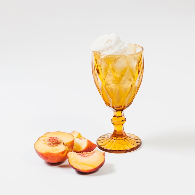 Peach near cup of ice-cream