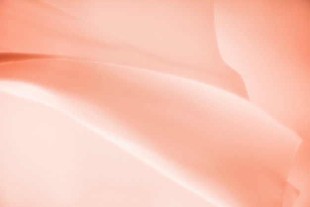 Free photo peach satin cloth texture background