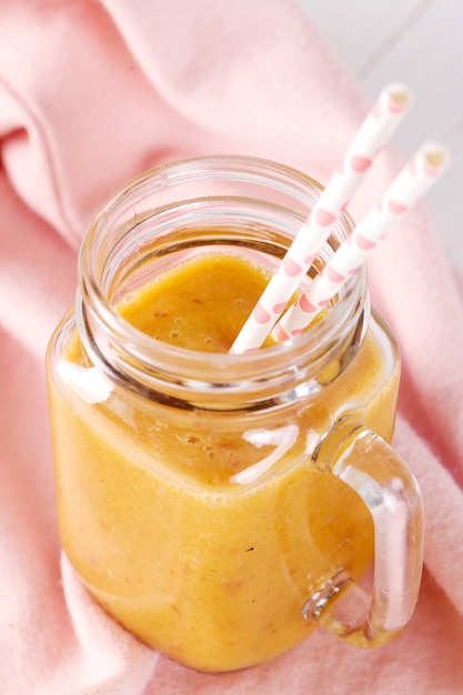 Peach smoothie with straws