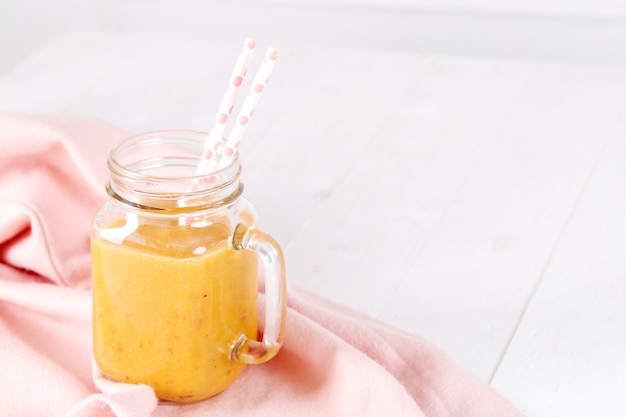 Peach smoothie with straws