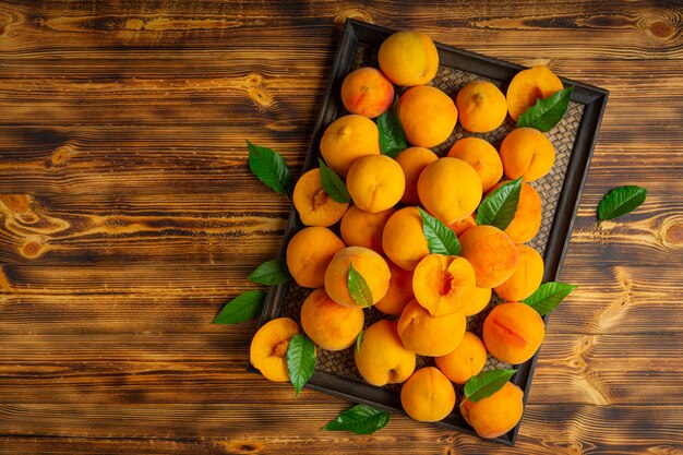 Peaches are placed on a wooden board.