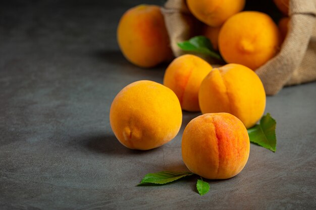 Peaches on a black surface