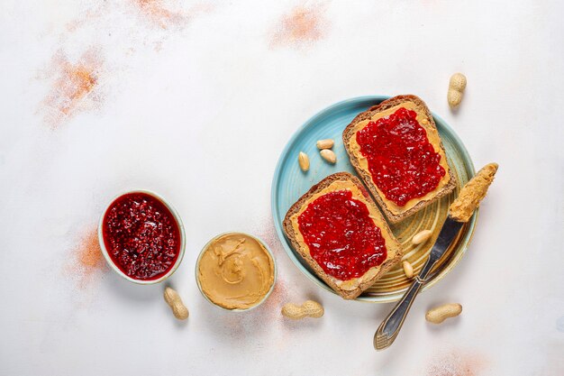 Peanut butter sandwiches or toasts with raspberry jam.