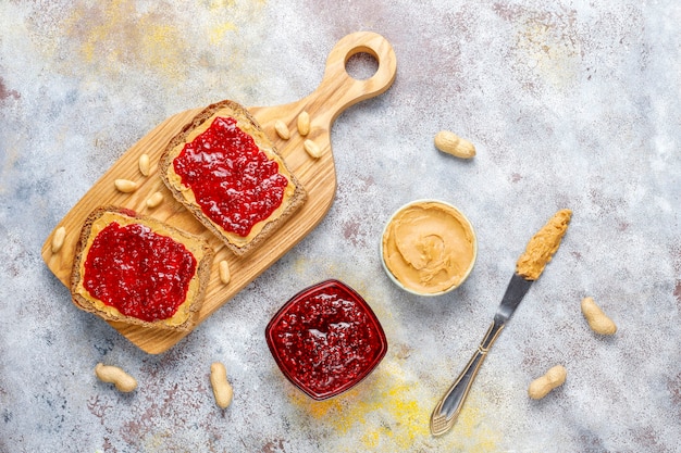 Peanut butter sandwiches or toasts with raspberry jam.