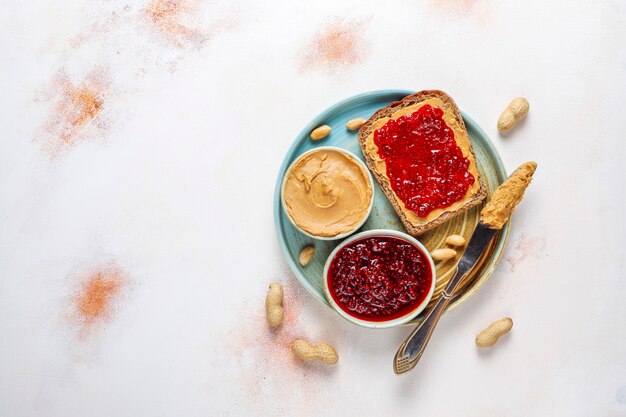 Peanut butter sandwiches or toasts with raspberry jam.