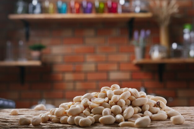 Peanut seeds on a wooden background in the kitchen