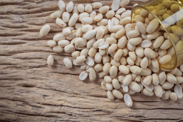 Peanut seeds on a wooden background in the kitchen