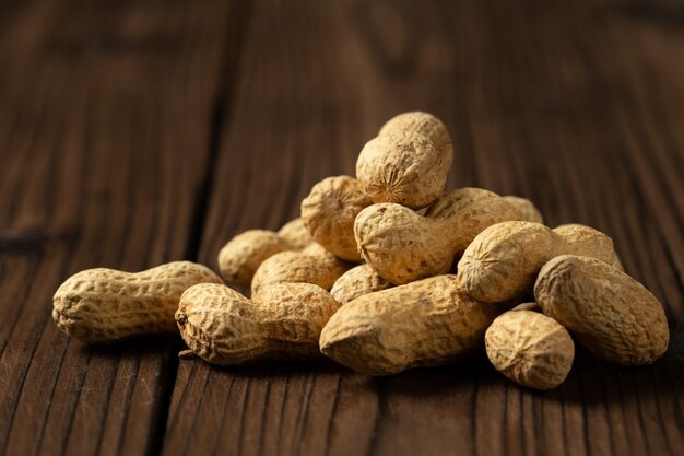 Peanuts in shells on wood  .
