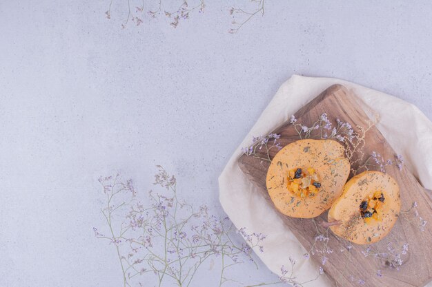 Pear slices with herbs and spices on a wooden board