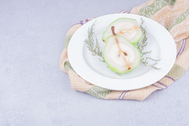 Pear slices with herbs in a white plate