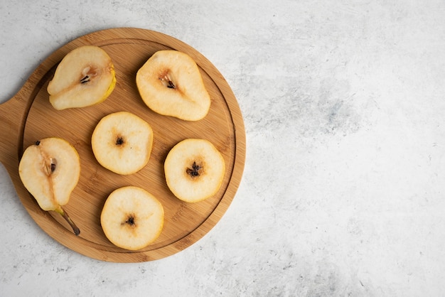 Free photo pear slices on a wooden board.