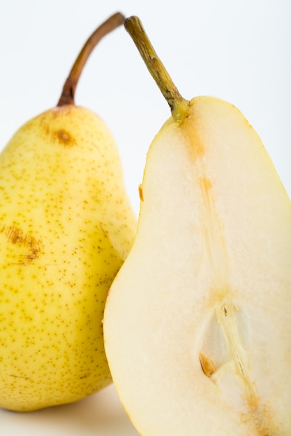 Pear yellow mellow juicy half cut isolated on white floor