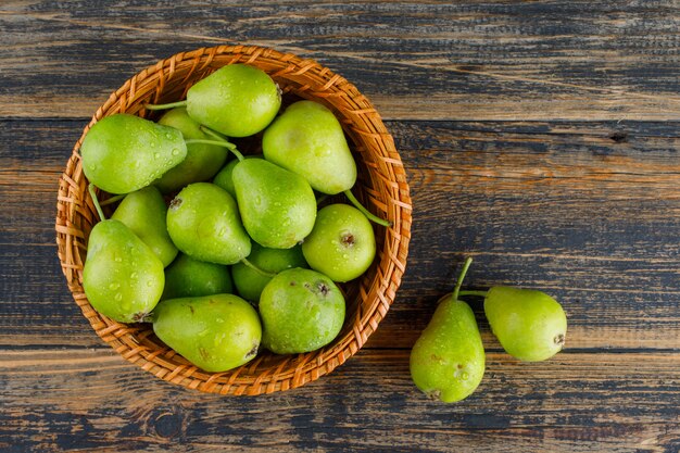 Pears in a basket flat lay on a wooden background