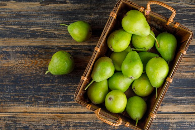 Pears in a basket top view on a wooden table