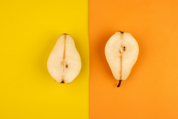 Free photo pears fresh ripe half cut on the colorful floor