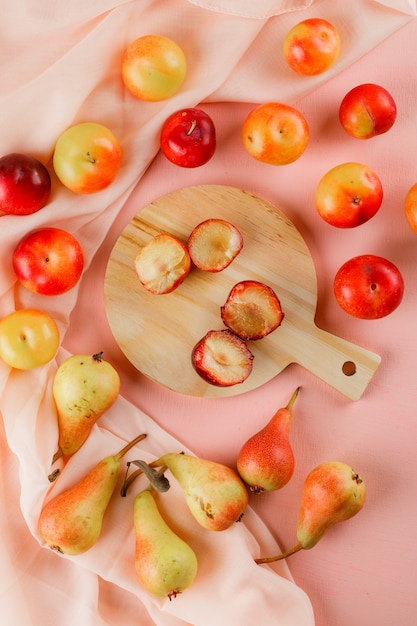 Pears and plums with cutting board