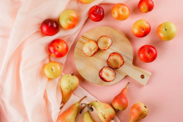 Pears and plums with cutting board