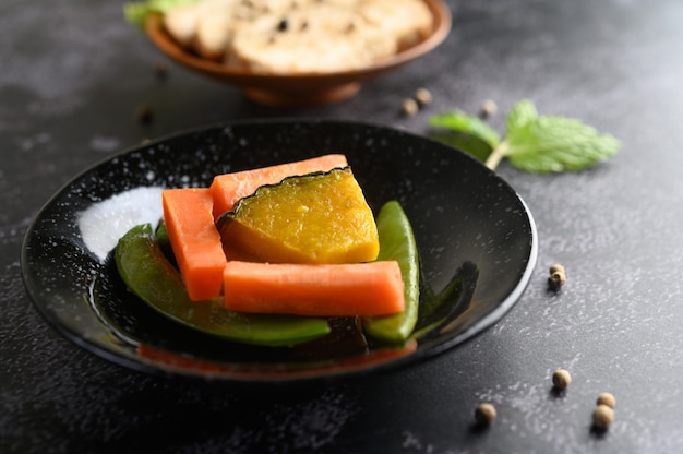 Peas, carrots and pumpkins on the plate