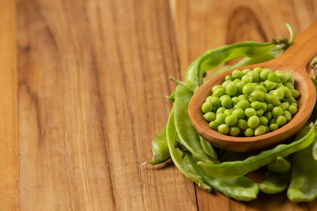 Peas laid on a wooden floor.