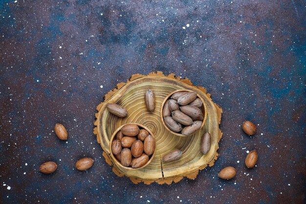 Pecan nuts on light background, top view