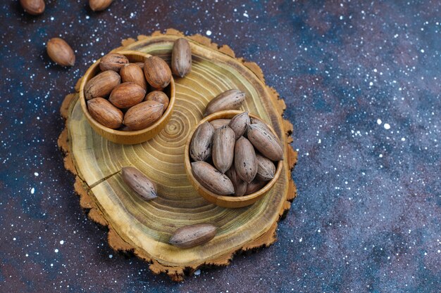 Pecan nuts on light background, top view