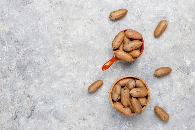 Pecan nuts on light background, top view