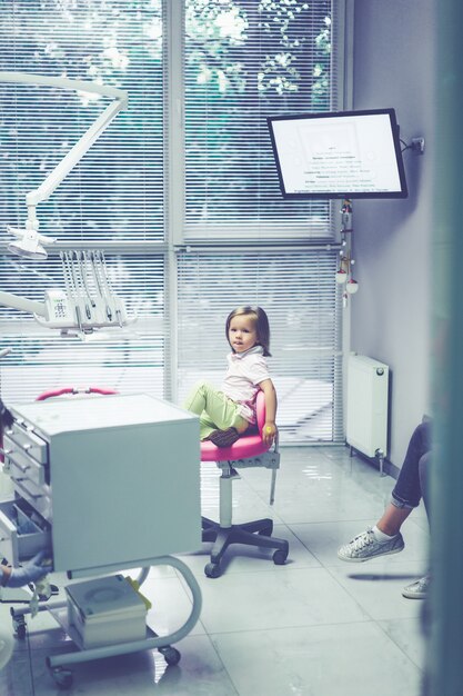 pediatric dentist. Little girl at the reception at the dentist.