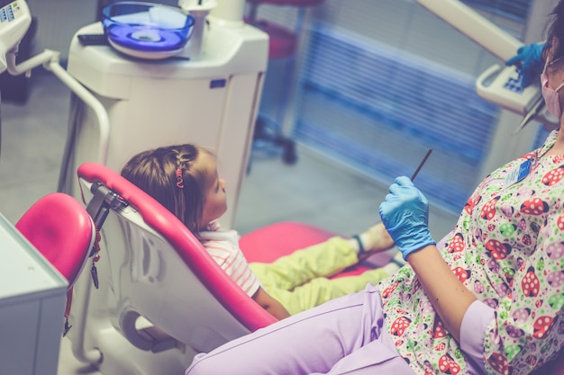 pediatric dentist. Little girl at the reception at the dentist.