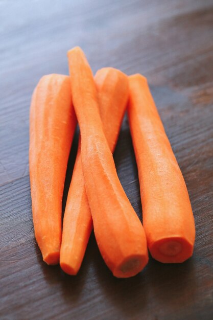 Peeled carrots isolated on the wooden table