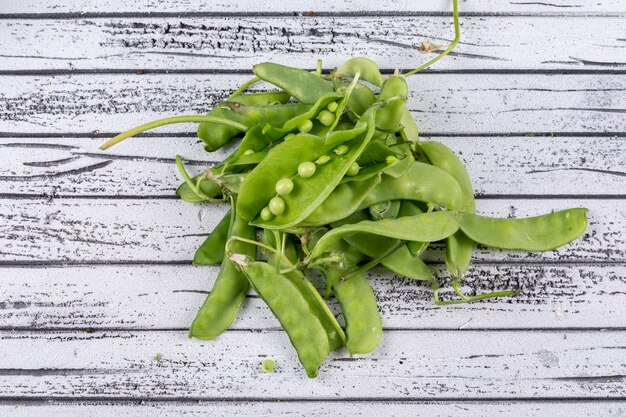 Peeled peas on a gray wooden surface