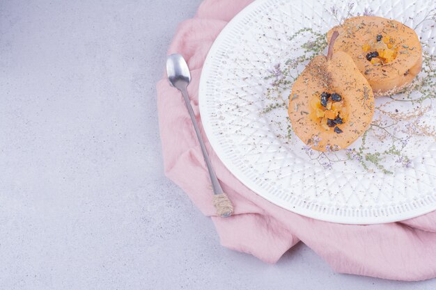 Peeled and sliced pear with herbs and spices in a white plate