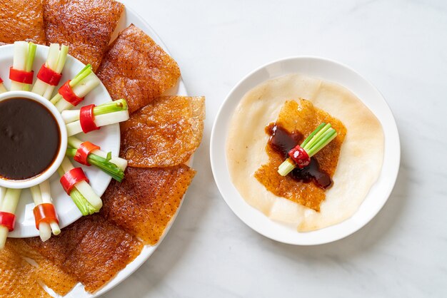 Premium Photo | Peking duck with sauce and ingredients