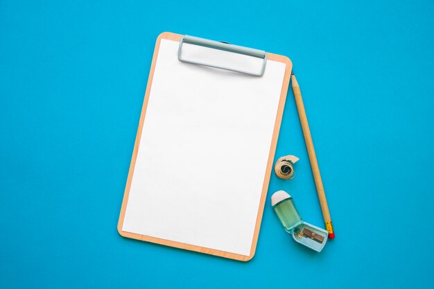 Pencil and sharpener near empty clipboard