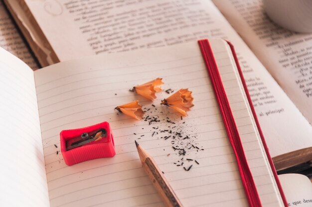 Pencil and sharpener on notepad and books