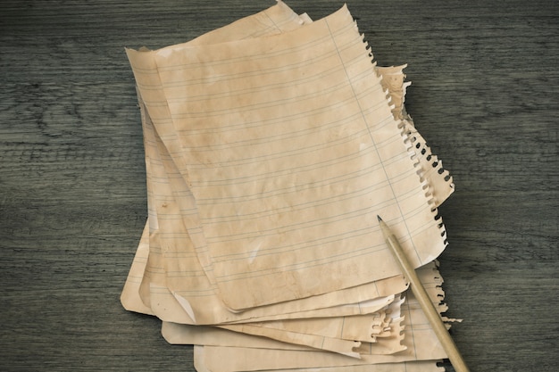 Pencil and stack of ruled paper