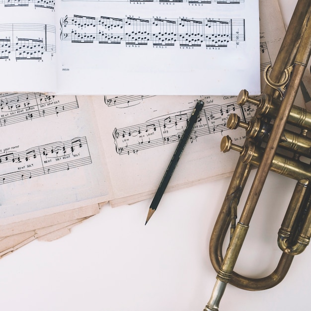 Free photo pencil and trumpet near sheet music