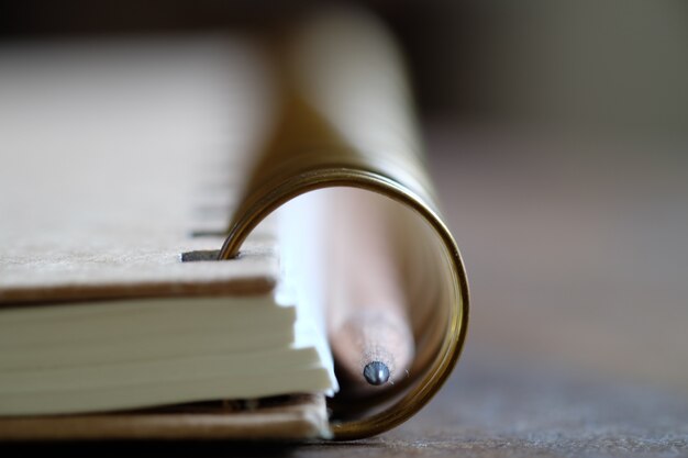 pencil with book on wood