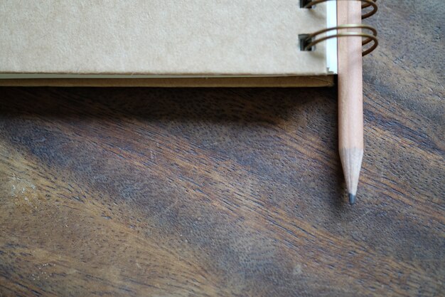 pencil with book on wood