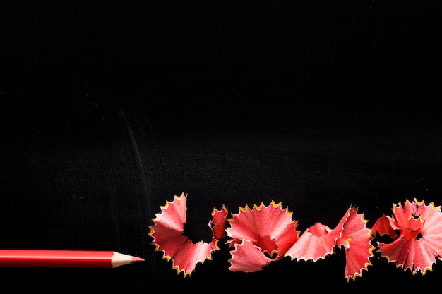 Pencil with shavings on black desk