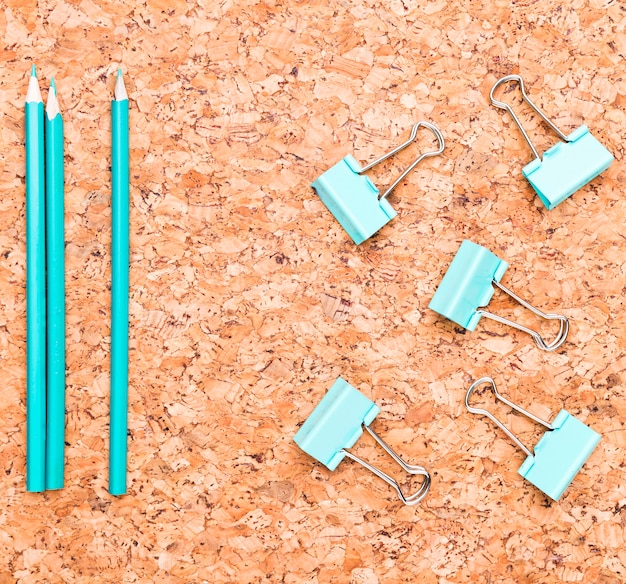 Pencils and binder clips on wooden table