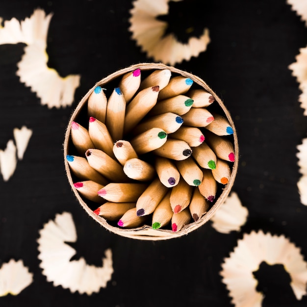 Free photo pencils in can and shavings on black background